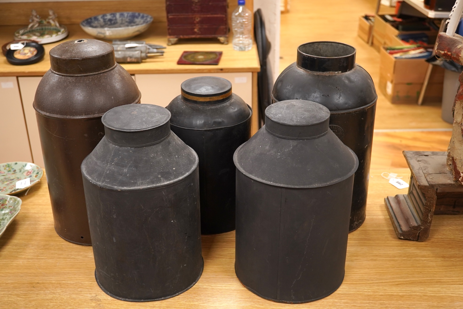 Five 19th century toleware tea canisters, largest 43cm
